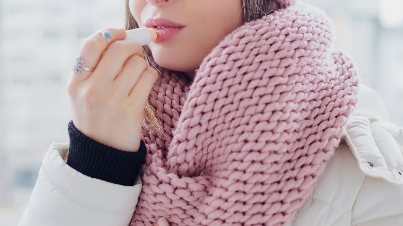 mulher-hidratante-labial-frio