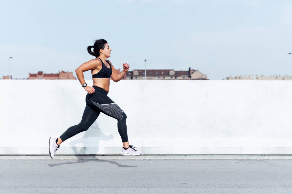 Young woman running training in the city