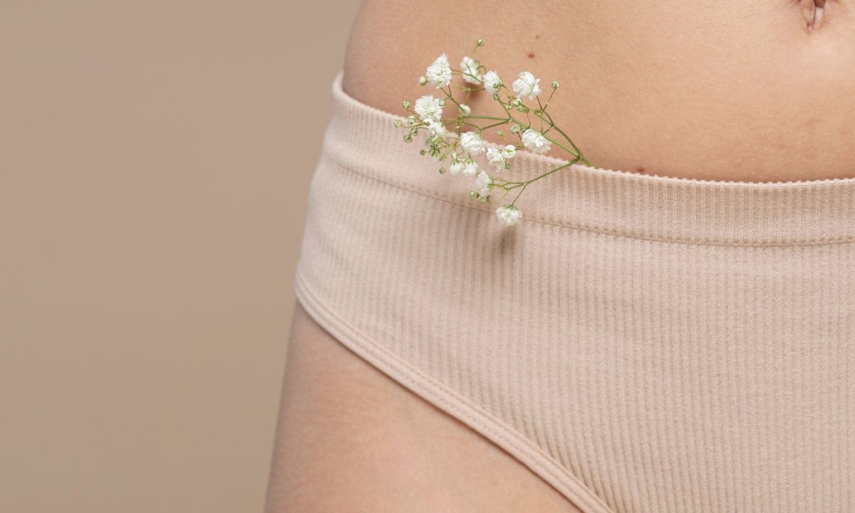 Mulher vestindo calcinha com um ramo de flores